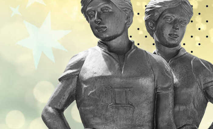 Twin statues stand against a starry, yellow background.